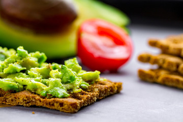 Avocado sandwich with avocado cream and rye crisp bread for snack. Fiber, fitness and diet food.