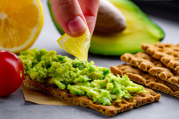 Avocado sandwich with avocado cream and rye crisp bread for snack. Fiber, fitness and diet food.