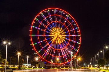High, glowing ferris wheel in the evening. Batumi, Georgia