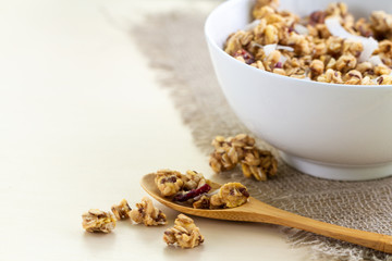 Dry breakfast cereals. Crunchy honey granola bowl with flax seeds, cranberries and coconut. Healthy, clean and fiber food. Copy space. Breakfast time