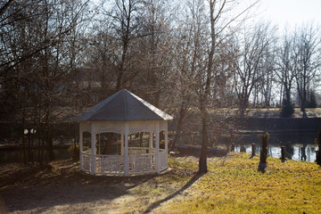 Fototapeta na wymiar Green park in winter season with arbour or bower
