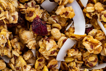 Dry breakfast cereals. Crunchy honey muesli bowl with slices of fresh banana and kiwi on a blue background. Raw diet and fiber food. Breakfast time