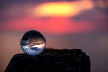  Upside down sunset landscape at Cape Kaliakra, Bulgaria, Eastern Europe - reflection in a lensball - selective focus, space for text