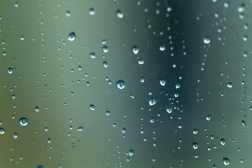 Naklejka na ściany i meble Raindrops texture. Drops on glass during rainy, wet, damp weather