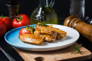 Grilled chicken wings with vegetables and herbs