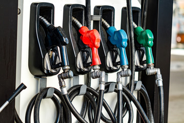 Petrol fuel pumps for filling the car at a gas station in the city.