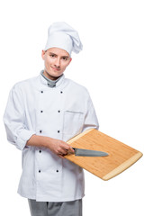 Cook in suit posing with a knife and cutting board on a white background in the studio