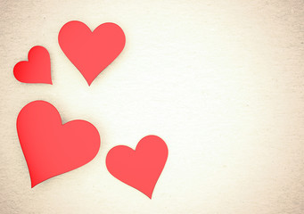 Valentine card. Four hearts on a paper background.