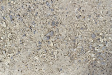The concrete floor was eroded, saw the sand stone mixture in the background.