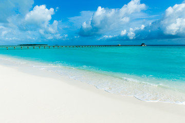 tropical Maldives island with white sandy beach and sea