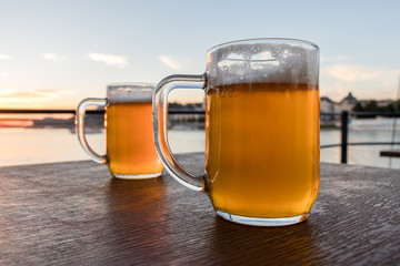 Two light beer glasses on the wooden table