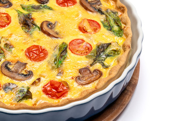 Baked homemade quiche pie in ceramic baking form