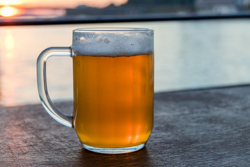 The glass of cold light beer with foam, traditional Slovak drink