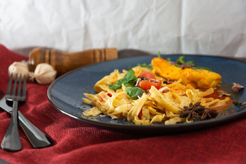 close-up of plate of pasta and chicken with lettuce