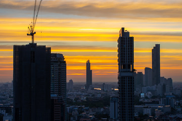 Bangkok Cityscape View at Evening Time.  Silhouette Business and Residential Building in Capital City of Thailand with Golden Sky in Background