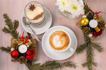 Panna Cotta with a cup of coffee and Christmas decorations on a wooden background.