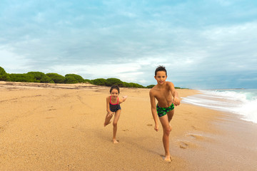 Kids playing on the beach. Active and  healthy childhood.