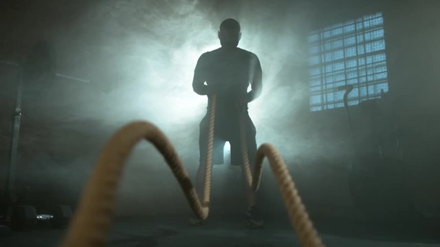Super slow motion of young man doing exercise with rope, filmed on high speed cinema camera, 500fps.