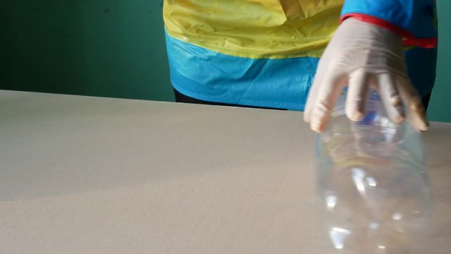 Recycling station, gloved hands sort the bottles