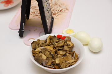 hostess with the help of a grater prepares the food
