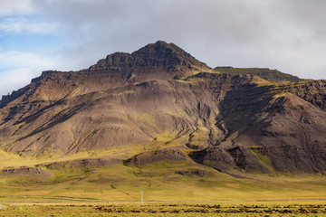 Large mountain range in Iceland covered with green grass