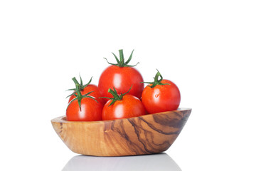 Fresh ripe tomatoes in wood bowl isolated on white background.