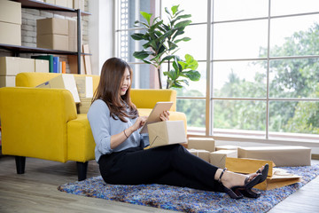 Young businesswoman success have new order from customer , Small working at home office packing box...