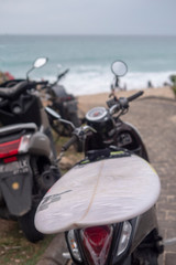 Scooters, motorcycles with surfboards on the background of the sea