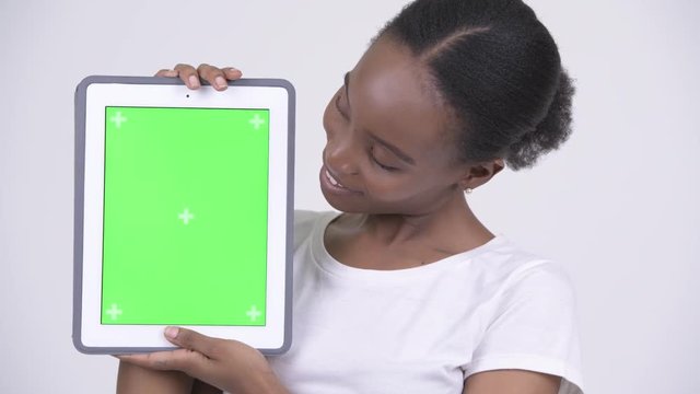 Face of happy young beautiful African woman showing digital tablet
