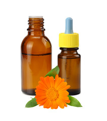bottle with marigold oil with marigold flowers isolated on white background. calendula flower.