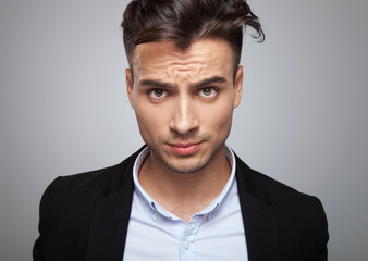 Obraz premium portrait of frustrated businessman in black suit standing