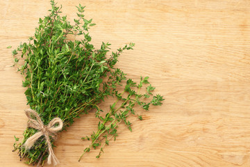 Thyme bunch on wooden background. top view