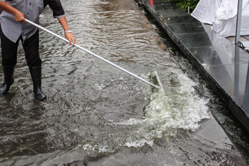 the worker use squeegee to squeeging water floor