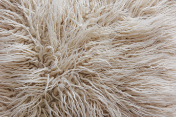 white fabric made of faux fur with long nap used for clothing and furniture and bedspreads