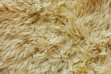 yellow fabric made of faux fur with long nap used for clothing and furniture and bedspreads	