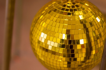 Golden mirror disco ball on a dark background