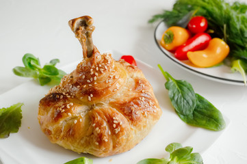 Chicken legs in dough with vegetables and lettuce.