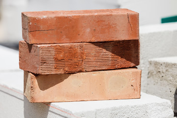 Stack of orange bricks on construction site