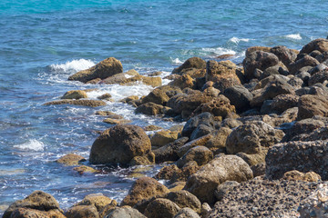 Waves break against the rocks.