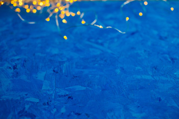 Christmas garland on a blue background. Bokeh