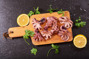 fresh cooked octopus with parsley and lemon, top view