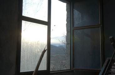 Abandoned home, window view, dark photo, view over the mountains