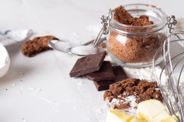 ingredients for baking chocolate cookies on white background.