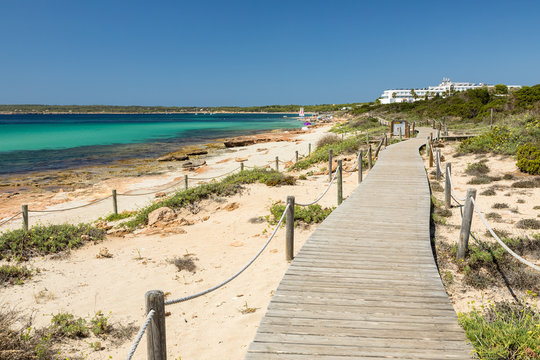 Wooden walking path along the Migjorn beach, Formentera island. Spain.
