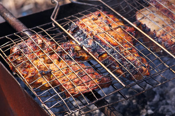 Pieces of pork meat roasted on the grill.