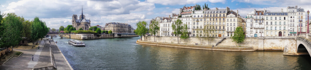 Fototapeta na wymiar Panorama with Notre Dame cathedral and boat on Seine in Paris, France