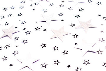 Silver star confetti on white background.