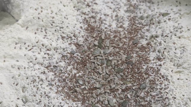 Add the seed mixture to the dough. slow motion