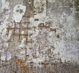 abstract texture of a destroyed wall with rusty fittings