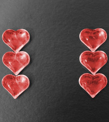 Obraz premium Red hearts on a black background.